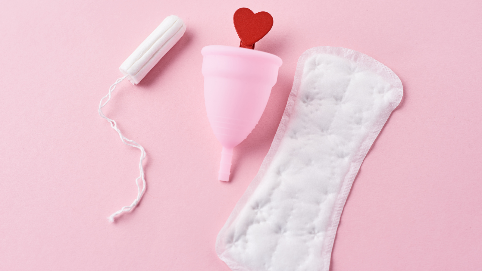 tampon, menstrual cup and pad on pink background